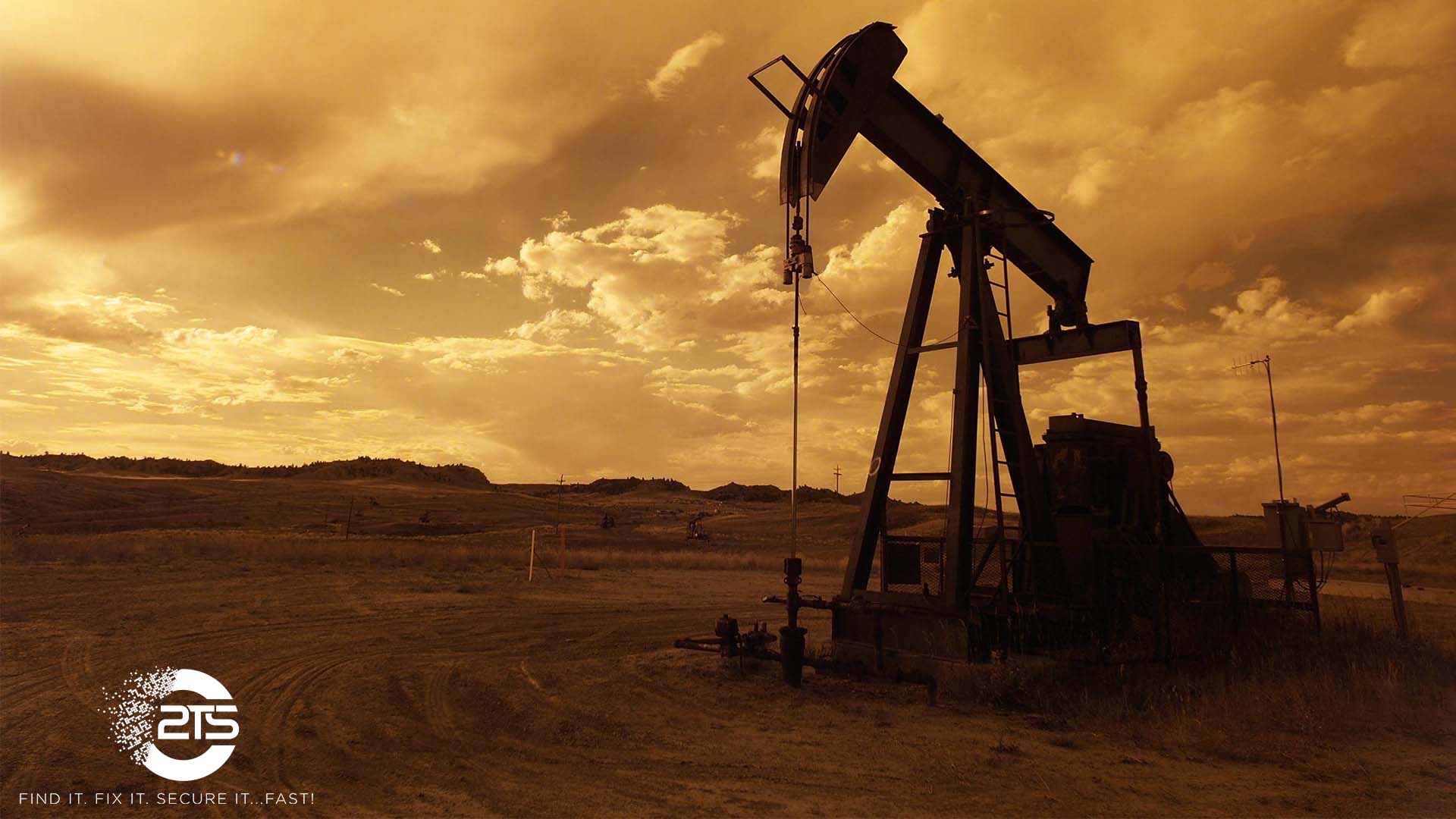 Oil pump surrounded by golden clouds at dusk